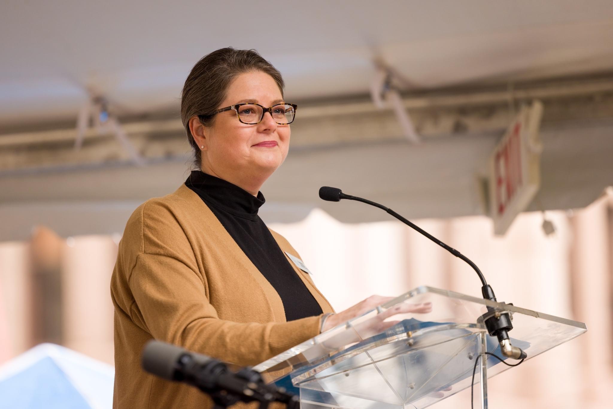 Threesa Sadler speaking at a podium
